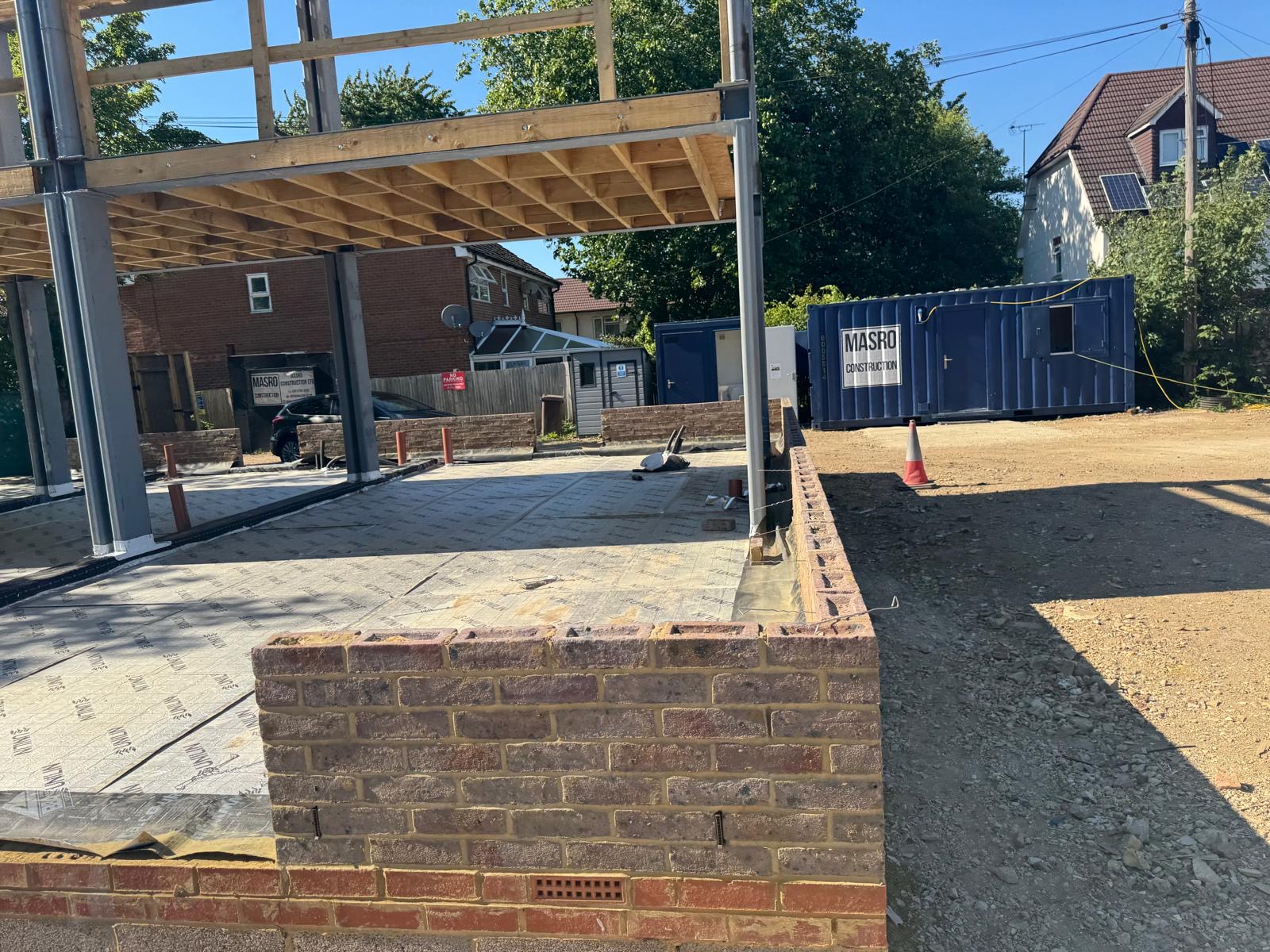 Ground floor beam and block steel frame above